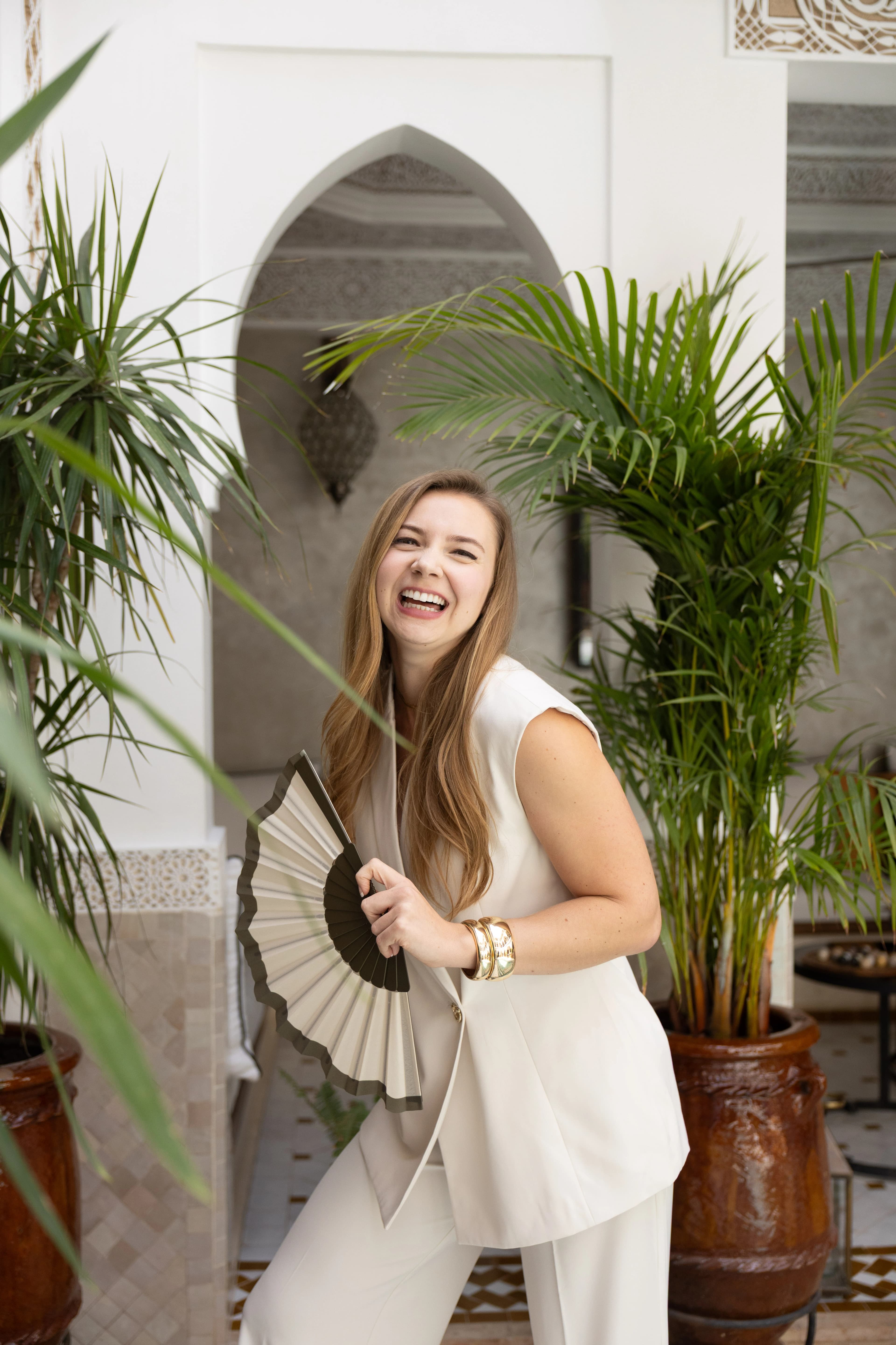 Madison laughing, holding a fan